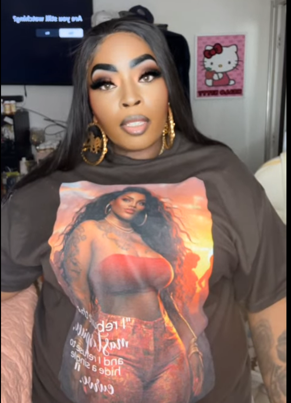 Bree wearing an oversized brown graphic tee from the Kall Her Beauti Say It With Your Chest™ Collection — roomy plus size statement tee with intentional design placement, buy one and receive a free Digital Daily™ Curvy Affirmations Card Deck, sizes S–5XL
